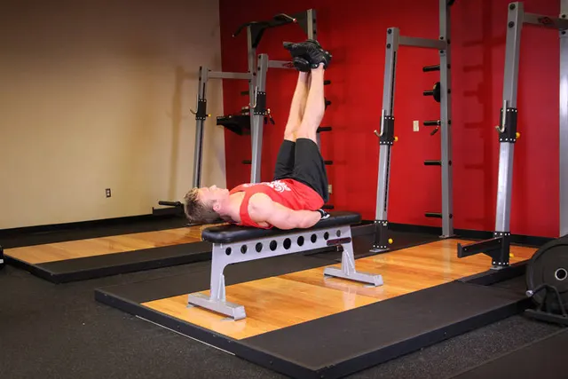 Flat Bench Lying Leg Raise, finishing position