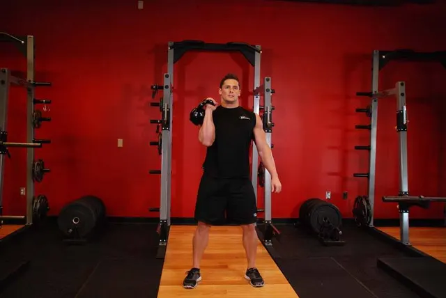 One-Arm Kettlebell Clean and Jerk, finishing position