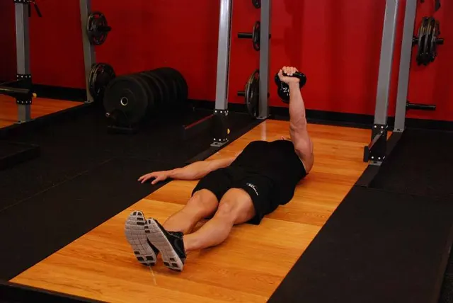 One-Arm Kettlebell Floor Press, finishing position