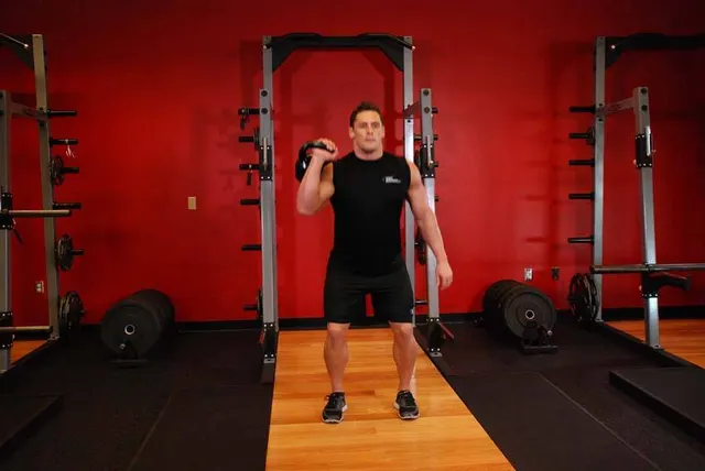 One-Arm Kettlebell Split Jerk, finishing position