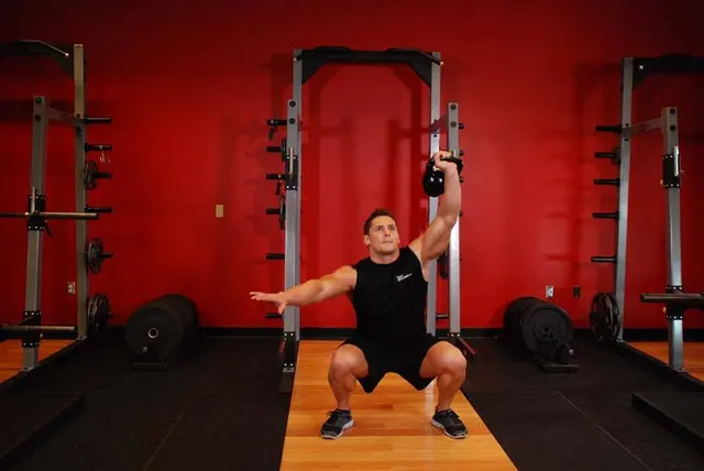 One-Arm Overhead Kettlebell Squats, finishing position