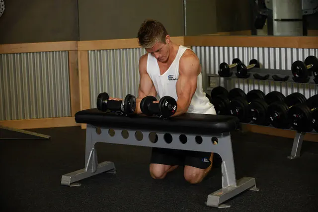 Palms-Up Dumbbell Wrist Curl Over A Bench, finishing position