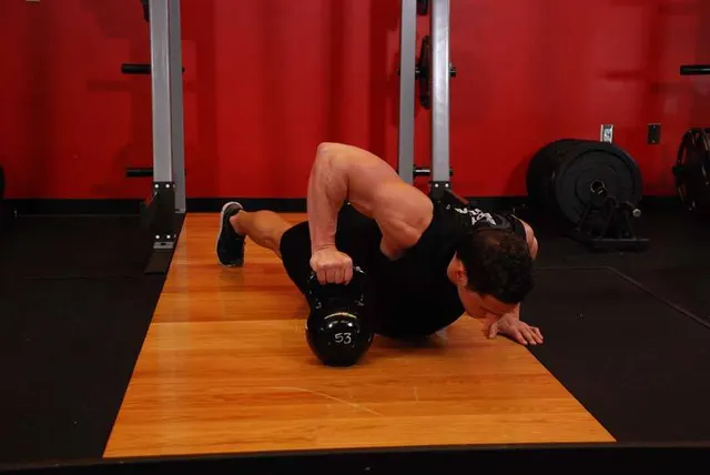 Plyo Kettlebell Pushups, finishing position