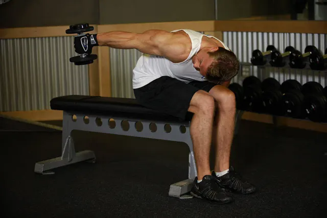 Seated Bent-Over One-Arm Dumbbell Triceps Extension, finishing position