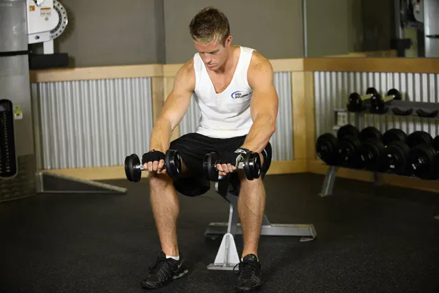 Seated Dumbbell Palms-Down Wrist Curl, finishing position