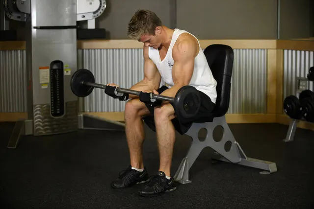 Seated Palm-Up Barbell Wrist Curl, finishing position