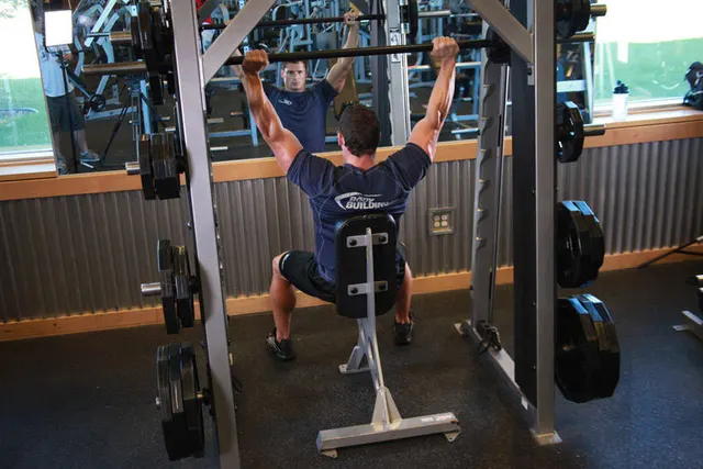 Smith Machine Overhead Shoulder Press, finishing position