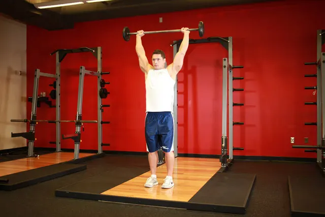 Standing Barbell Press Behind Neck, finishing position