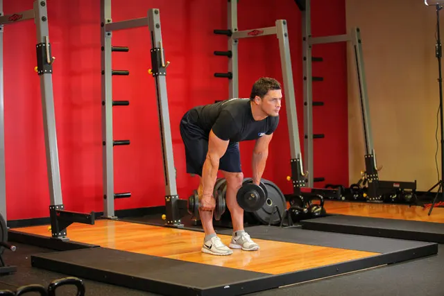 Stiff-Legged Dumbbell Deadlift, finishing position